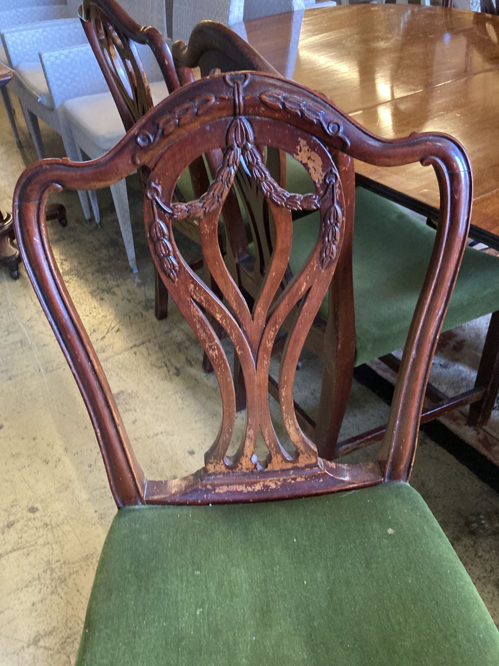 A set of seven George III style mahogany dining chairs (one with arms) together with a mahogany twin pillar extending dining table, 208